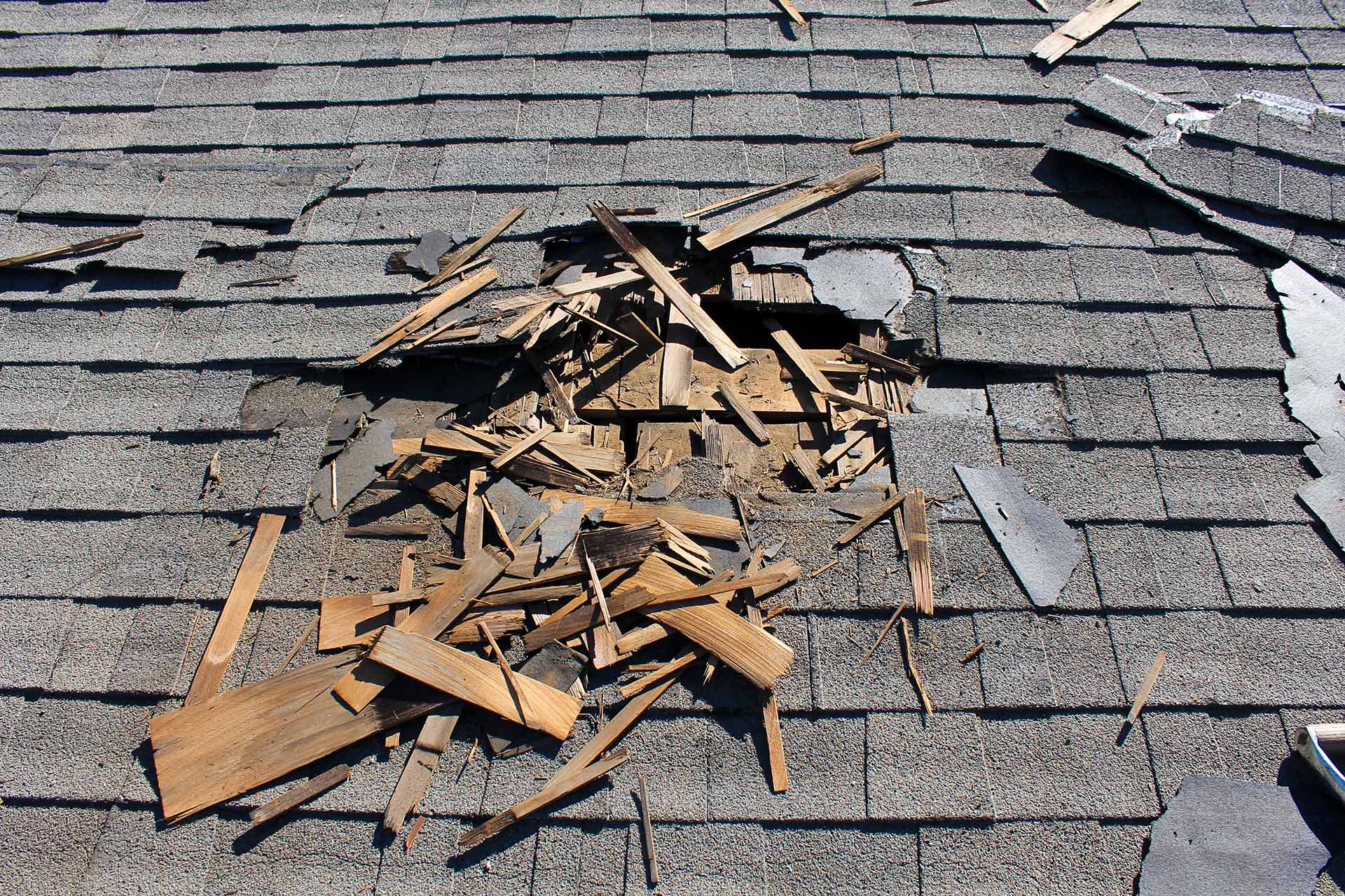 A badly damaged home roof needing repairs in Wesley Chapel, FL.