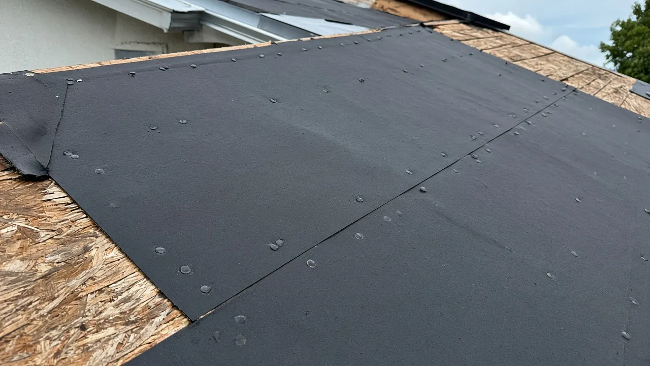 Black underlayment fastened to the deck on dry-in day